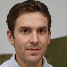 Joyful white adult male with short  brown hair and brown eyes