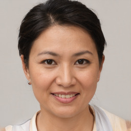 Joyful white adult female with short  brown hair and brown eyes