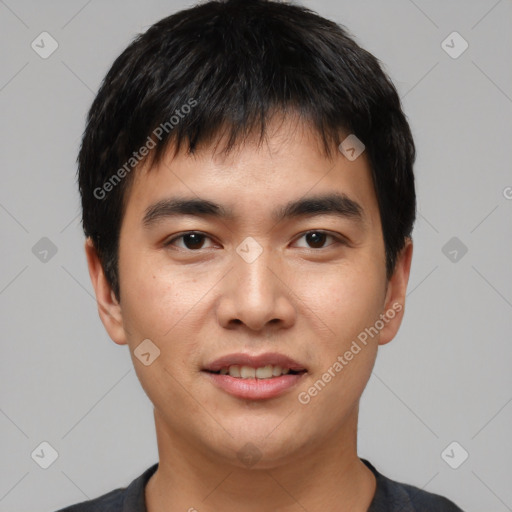 Joyful asian young-adult male with short  black hair and brown eyes