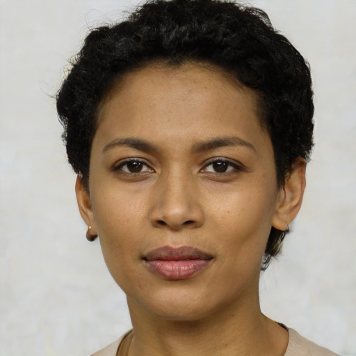 Joyful latino young-adult female with short  black hair and brown eyes