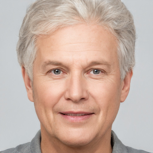 Joyful white middle-aged male with short  gray hair and grey eyes