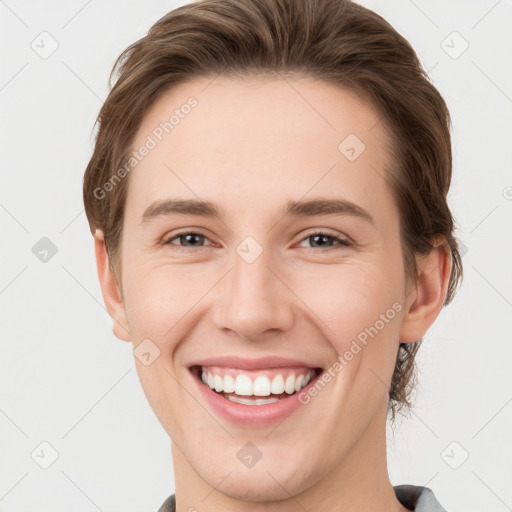 Joyful white young-adult female with short  brown hair and grey eyes