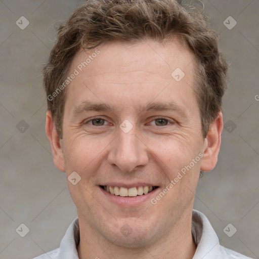 Joyful white adult male with short  brown hair and grey eyes