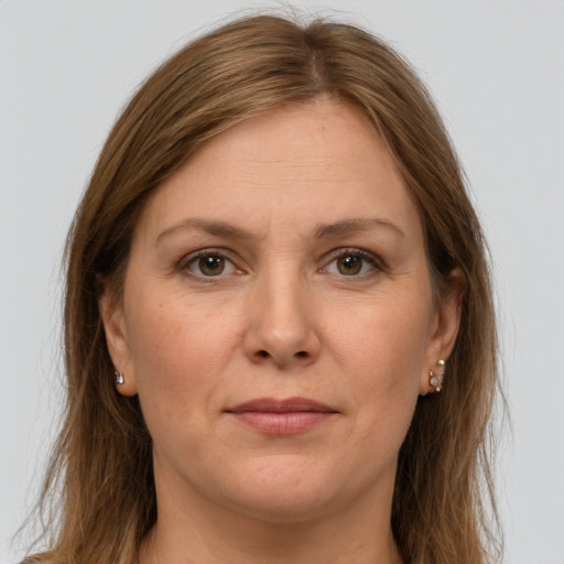 Joyful white adult female with long  brown hair and grey eyes