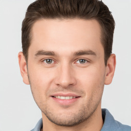 Joyful white young-adult male with short  brown hair and brown eyes