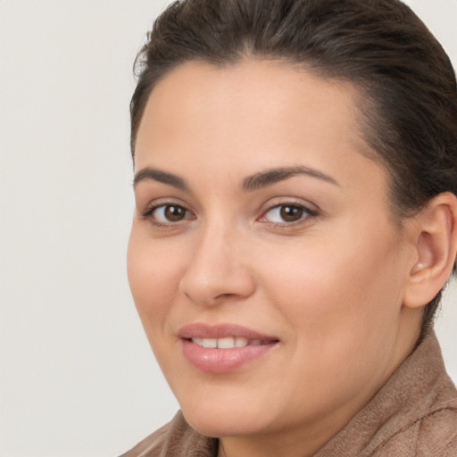 Joyful white young-adult female with long  brown hair and brown eyes