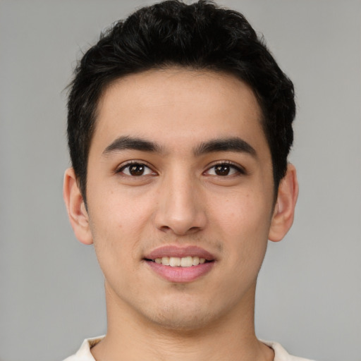Joyful latino young-adult male with short  brown hair and brown eyes