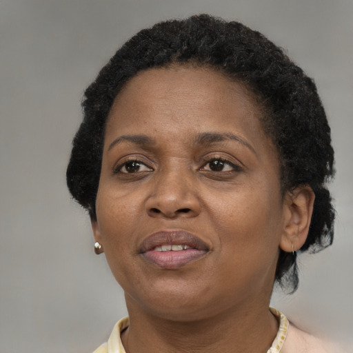 Joyful black adult female with short  brown hair and brown eyes