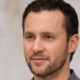 Joyful white adult male with short  brown hair and brown eyes