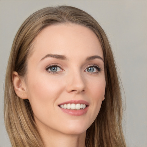 Joyful white young-adult female with long  brown hair and grey eyes