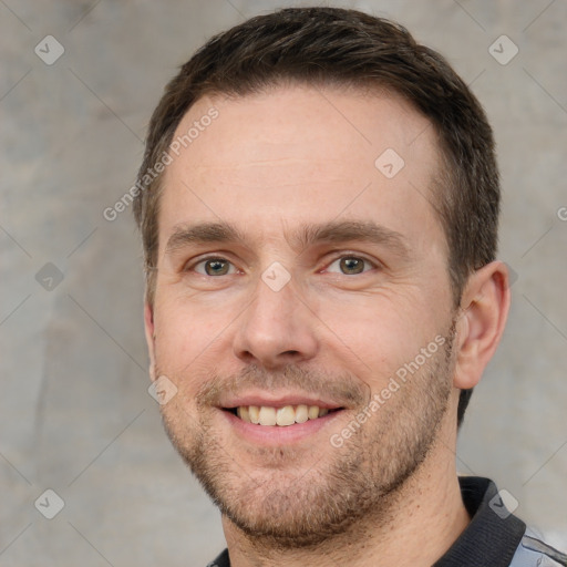 Joyful white adult male with short  brown hair and brown eyes