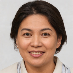 Joyful white adult female with medium  brown hair and brown eyes