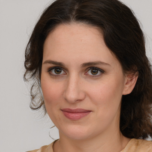 Joyful white young-adult female with medium  brown hair and brown eyes