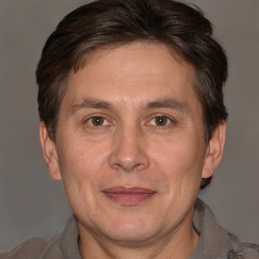 Joyful white adult male with short  brown hair and brown eyes