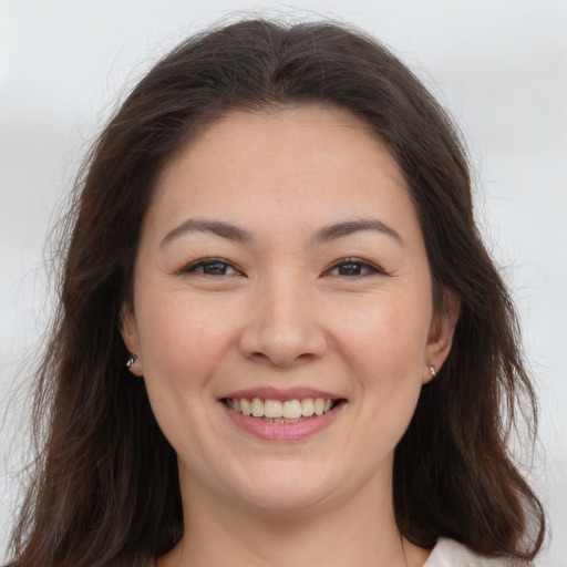 Joyful white young-adult female with long  brown hair and brown eyes