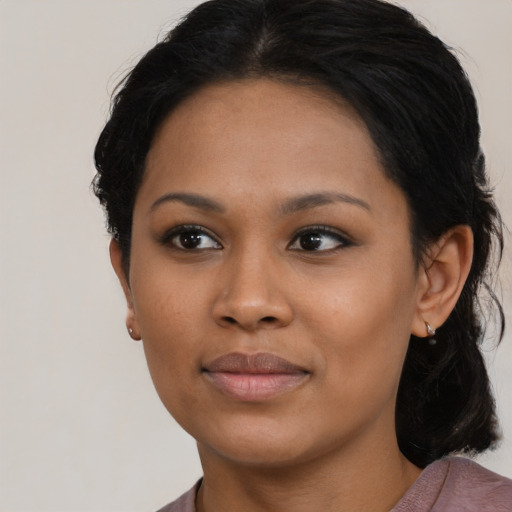 Joyful black young-adult female with medium  black hair and brown eyes
