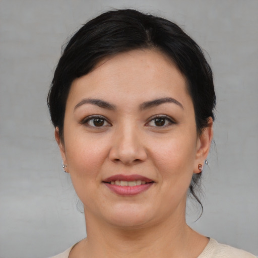Joyful white young-adult female with medium  black hair and brown eyes