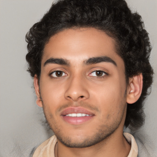 Joyful latino young-adult male with short  brown hair and brown eyes