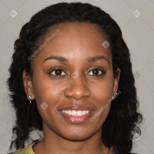 Joyful black young-adult female with long  brown hair and brown eyes