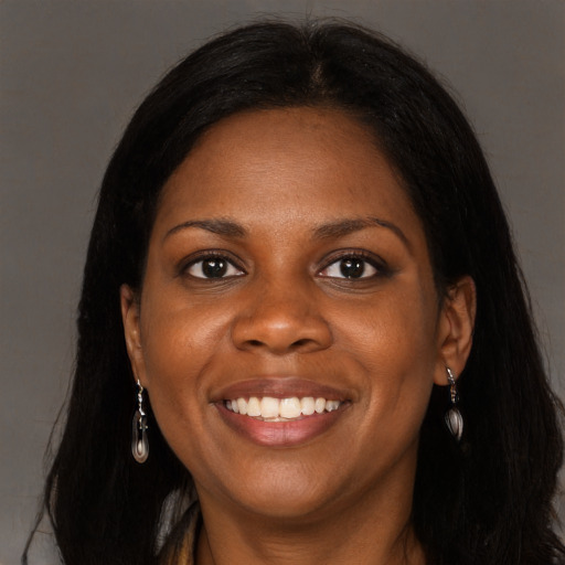 Joyful black young-adult female with long  brown hair and brown eyes