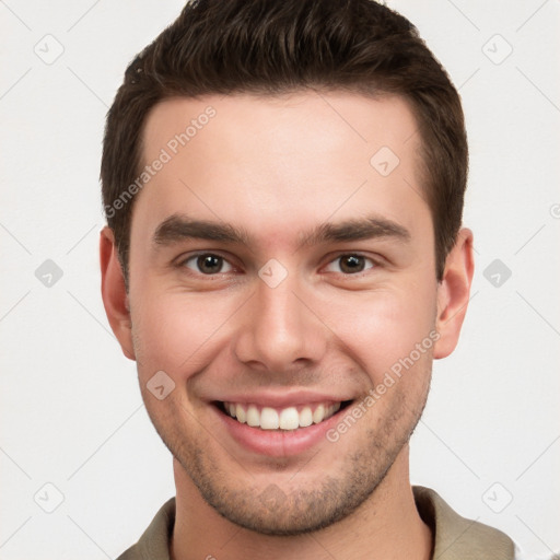 Joyful white young-adult male with short  brown hair and brown eyes