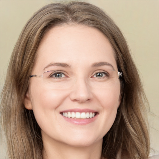 Joyful white young-adult female with long  brown hair and green eyes