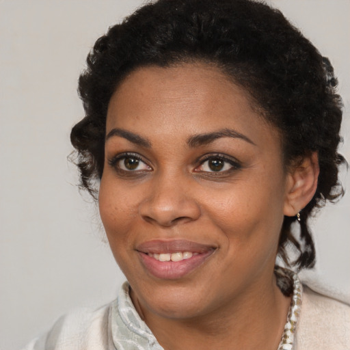 Joyful black young-adult female with short  brown hair and brown eyes
