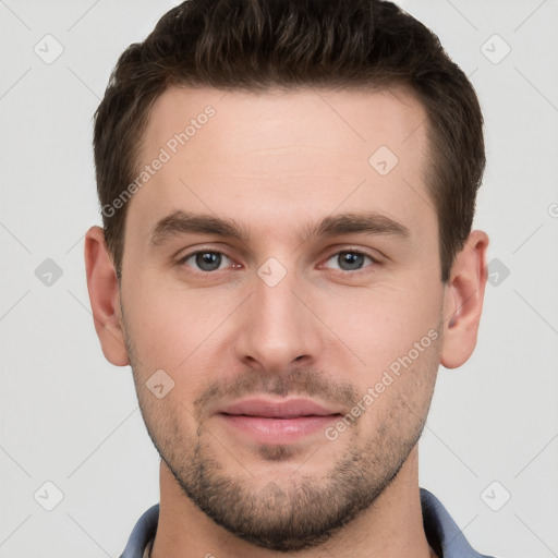 Joyful white young-adult male with short  brown hair and grey eyes