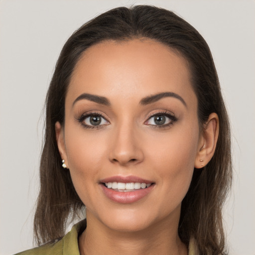 Joyful white young-adult female with long  brown hair and brown eyes