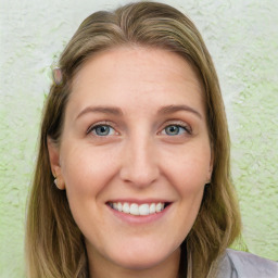 Joyful white young-adult female with long  brown hair and blue eyes