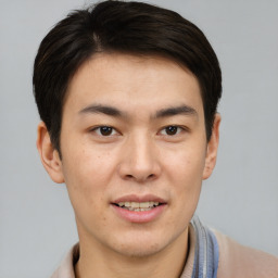 Joyful asian young-adult male with short  brown hair and brown eyes