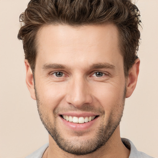 Joyful white young-adult male with short  brown hair and brown eyes