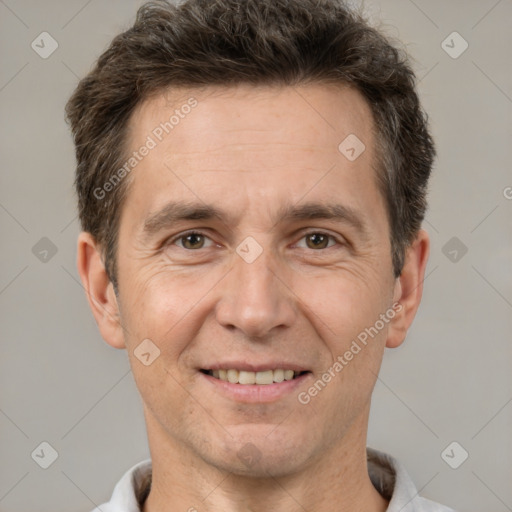 Joyful white adult male with short  brown hair and brown eyes