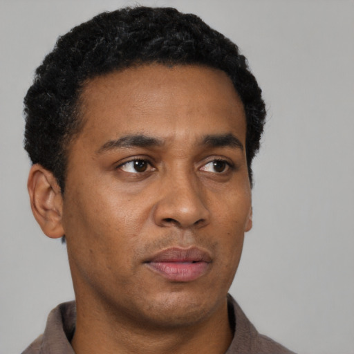 Neutral black young-adult male with short  black hair and brown eyes