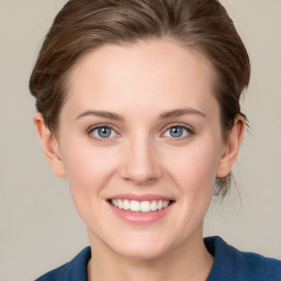 Joyful white young-adult female with medium  brown hair and blue eyes