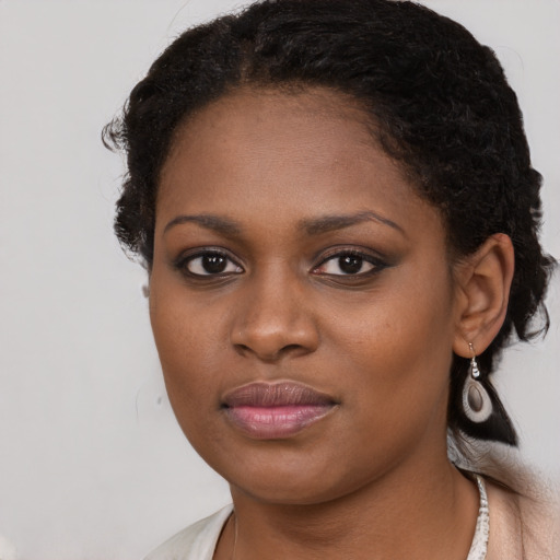 Joyful black young-adult female with medium  black hair and brown eyes