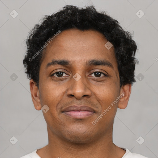 Joyful latino young-adult male with short  brown hair and brown eyes