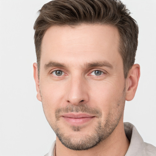 Joyful white young-adult male with short  brown hair and grey eyes