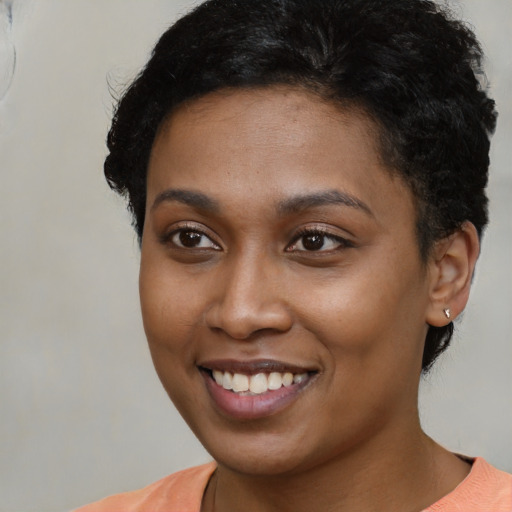 Joyful latino young-adult female with short  brown hair and brown eyes