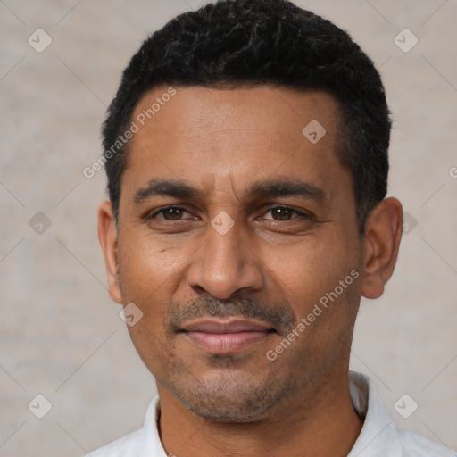 Joyful latino adult male with short  black hair and brown eyes