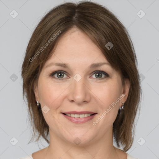 Joyful white adult female with medium  brown hair and grey eyes