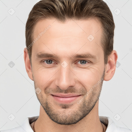 Joyful white young-adult male with short  brown hair and brown eyes