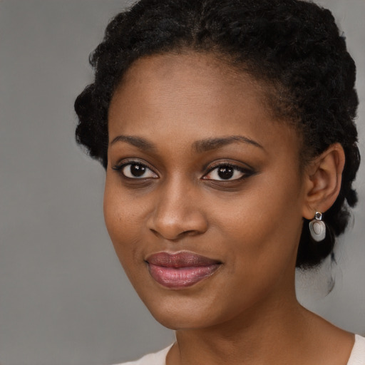 Joyful black young-adult female with medium  black hair and brown eyes