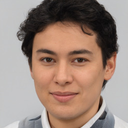 Joyful latino young-adult male with short  brown hair and brown eyes