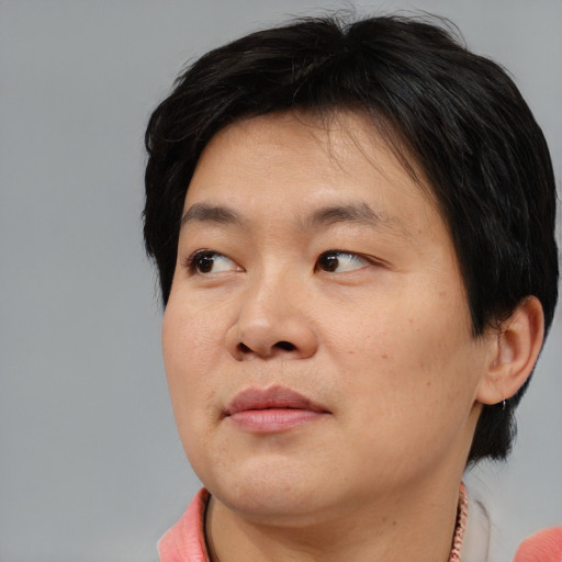 Joyful asian young-adult male with medium  brown hair and brown eyes