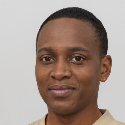 Joyful black young-adult male with short  black hair and brown eyes