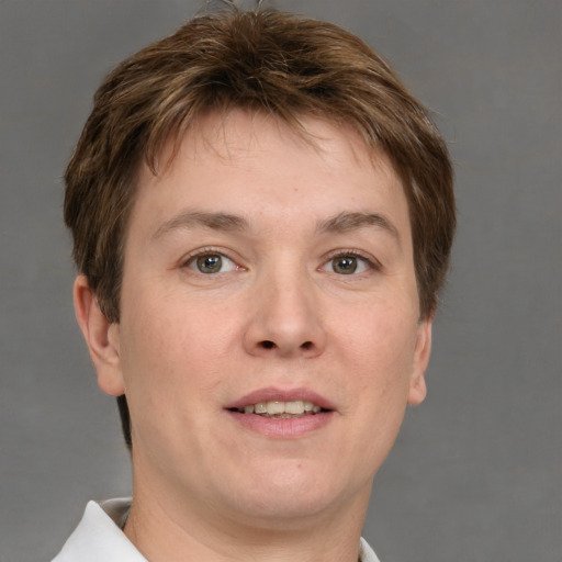 Joyful white adult male with short  brown hair and grey eyes