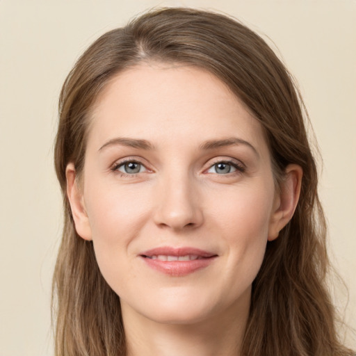 Joyful white young-adult female with long  brown hair and grey eyes