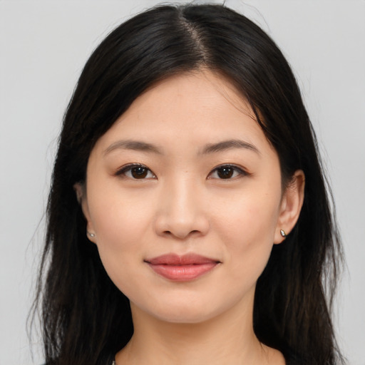 Joyful asian young-adult female with long  black hair and brown eyes