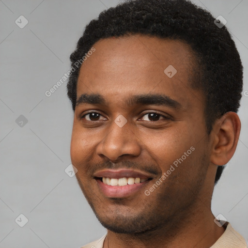 Joyful black young-adult male with short  black hair and brown eyes